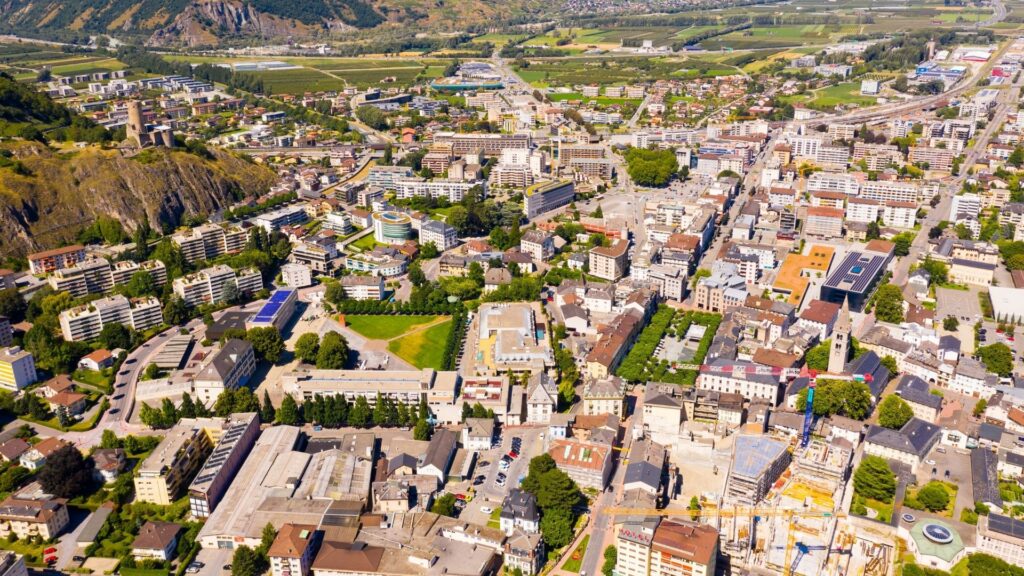 Aerial view of Martigny modern cityscape in the Rhone Valley at the foot of the Swiss Alps on a sunny summer day, canton of Valais.