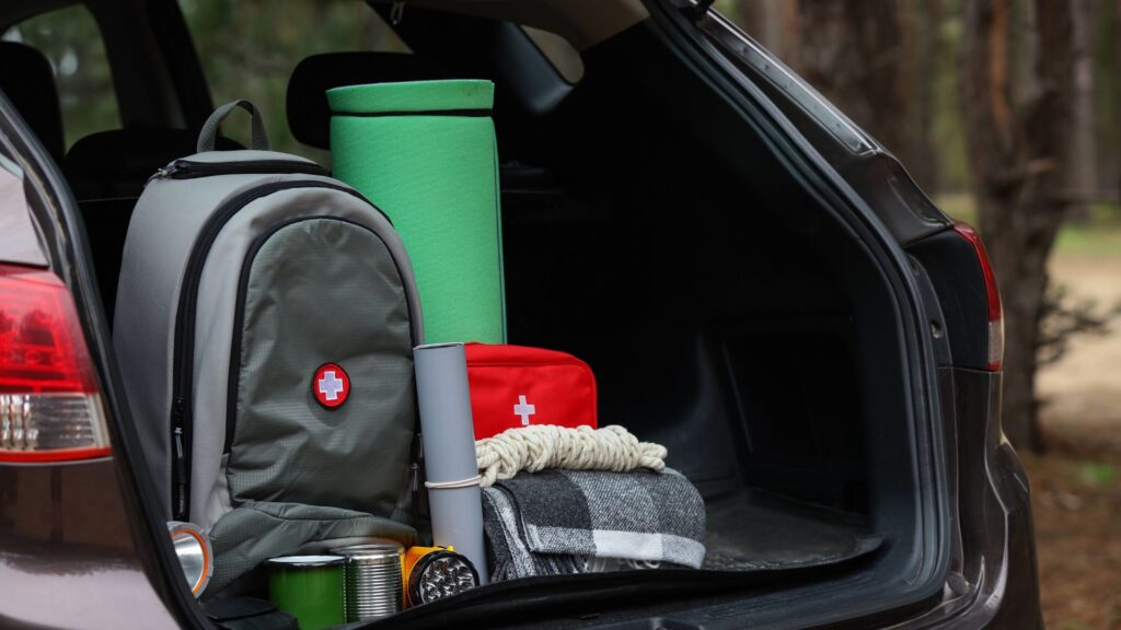 Open car trunk packed with emergency supplies.
